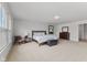 Bright bedroom featuring two large windows, neutral carpet, and modern furniture at 5637 Woodland Trace Blvd, Indianapolis, IN 46237