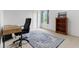 Bright bedroom featuring an office setup, complete with a desk, bookshelf and blue rug at 5637 Woodland Trace Blvd, Indianapolis, IN 46237