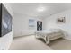 Well-lit bedroom with carpet flooring, a cozy bed, and modern art at 5637 Woodland Trace Blvd, Indianapolis, IN 46237