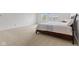 Bright bedroom featuring a large window, neutral carpet, and modern furniture at 5637 Woodland Trace Blvd, Indianapolis, IN 46237