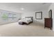 Bright bedroom featuring two large windows, neutral carpet, and modern furniture at 5637 Woodland Trace Blvd, Indianapolis, IN 46237