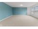 Spacious bonus room with natural lighting, neutral colors, and carpet flooring at 5637 Woodland Trace Blvd, Indianapolis, IN 46237