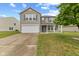 Charming two-story home features a two-car garage, covered front porch, and well-manicured lawn at 5637 Woodland Trace Blvd, Indianapolis, IN 46237