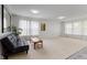 Spacious living room offers bright natural light, plush carpeting, and a decorative mirror at 5637 Woodland Trace Blvd, Indianapolis, IN 46237