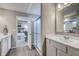 Modern bathroom featuring double vanity, glass shower and wood look flooring with a glimpse into the main bedroom at 587 Bluestem Ln, New Whiteland, IN 46184