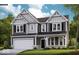 Charming two-story home with gray siding, black shutters, landscaped yard and attached two car garage at 587 Bluestem Ln, New Whiteland, IN 46184