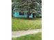 Charming single-story home with vibrant blue siding and a well-maintained front yard, shaded by a mature tree at 5938 Price Ln, Indianapolis, IN 46254