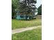Charming single-story home with vibrant blue siding and a well-maintained front yard, shaded by a mature tree at 5938 Price Ln, Indianapolis, IN 46254