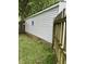 View of the side of the detached garage, showing the siding, trim, and access to the backyard at 5938 Price Ln, Indianapolis, IN 46254