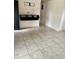 Spacious living area with tile floors and built-in shelving near the front entry at 5938 Price Ln, Indianapolis, IN 46254