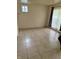 A bright living room features tile floors, paneled walls and window with natural light at 5938 Price Ln, Indianapolis, IN 46254
