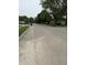 View of the street with neatly manicured lawns and mature trees in a quiet neighborhood at 5938 Price Ln, Indianapolis, IN 46254