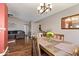 Dining room with hardwood floors, a chandelier, and a view of the living room at 5967 Peregrine Blvd, Indianapolis, IN 46228