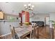 Dining room with hardwood floors, a chandelier, and a view of the living room and kitchen at 5967 Peregrine Blvd, Indianapolis, IN 46228