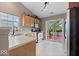 Functional kitchen with wood cabinets, stainless steel appliances, and a view to the outdoor deck at 5967 Peregrine Blvd, Indianapolis, IN 46228