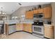 Functional kitchen with wood cabinets, stainless steel appliances, and plenty of counter space at 5967 Peregrine Blvd, Indianapolis, IN 46228