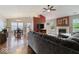 Open-concept living area featuring a fireplace, hardwood floors, and a view of the dining area at 5967 Peregrine Blvd, Indianapolis, IN 46228