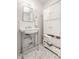 Classic bathroom features include pedestal sink, marble floors, white cabinets and plenty of storage at 611 N Park Ave # 104, Indianapolis, IN 46204