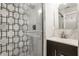 Bathroom featuring a tiled shower with glass door, and a modern vanity with a mirror at 611 N Park Ave # 104, Indianapolis, IN 46204