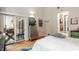Spacious bedroom with hardwood floors, modern decor, glass sliding doors, and closet space at 611 N Park Ave # 104, Indianapolis, IN 46204