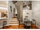 Open concept dining area with wood floors, exposed concrete, and stairway to the upper level at 611 N Park Ave # 104, Indianapolis, IN 46204