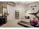 Exercise room with treadmill, exposed concrete, neutral paint color, and decorative shelves at 611 N Park Ave # 104, Indianapolis, IN 46204