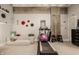 Carpeted exercise room featuring fitness equipment, and neutral paint color, exposed concrete, and decorative shelves at 611 N Park Ave # 104, Indianapolis, IN 46204