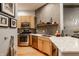 Kitchen with marble counters, stainless steel appliances, and open shelving with decorative dishware at 611 N Park Ave # 104, Indianapolis, IN 46204