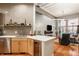 Open kitchen with stainless steel appliances and island that features marble countertops at 611 N Park Ave # 104, Indianapolis, IN 46204