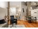 Stylish living room with hardwood floors and a view of the open kitchen and dining area at 611 N Park Ave # 104, Indianapolis, IN 46204