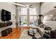 Spacious living room with high ceilings, hardwood flooring, and access to an outdoor patio at 611 N Park Ave # 104, Indianapolis, IN 46204