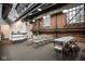 An open meeting space with exposed brick, overhead lighting, and table and chairs at 611 N Park Ave # 104, Indianapolis, IN 46204