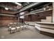 An open meeting space with exposed brick, overhead lighting, and table and chairs at 611 N Park Ave # 104, Indianapolis, IN 46204