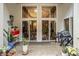 Covered patio with sliding glass doors, plants, and modern decor provides a seamless indoor-outdoor living experience at 611 N Park Ave # 104, Indianapolis, IN 46204