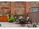 Cozy brick patio with string lights, outdoor seating, and lush greenery creating an inviting outdoor space at 611 N Park Ave # 104, Indianapolis, IN 46204