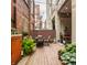 Outdoor patio featuring wood floors, string lights, outdoor seating, and lush plants creating an inviting ambiance at 611 N Park Ave # 104, Indianapolis, IN 46204