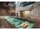 Indoor pool with brick walls, a jacuzzi, and workout equipment for exercise and relaxation in any weather at 611 N Park Ave # 104, Indianapolis, IN 46204