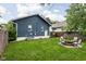 Backyard featuring a fire pit with chairs, ideal for outdoor entertainment and relaxation at 614 N Drexel Ave, Indianapolis, IN 46201