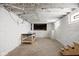 Spacious unfinished basement with exposed ceiling and concrete floors, offering potential for customization at 614 N Drexel Ave, Indianapolis, IN 46201