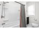 Clean bathroom showcasing a shower and tub combo with modern fixtures and a stylish shower curtain at 614 N Drexel Ave, Indianapolis, IN 46201