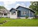 Charming blue house with a white-painted brick porch and a well-manicured lawn at 614 N Drexel Ave, Indianapolis, IN 46201