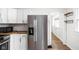 Modern kitchen with stainless steel refrigerator and white cabinets at 614 N Drexel Ave, Indianapolis, IN 46201