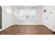 Bright living room with wood floors, white walls, and a large window at 614 N Drexel Ave, Indianapolis, IN 46201