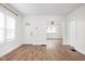 Open-concept living room with wood floors, white walls, and abundant natural light at 614 N Drexel Ave, Indianapolis, IN 46201
