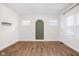 Cozy living room showcasing wood floors, white walls, and an arched wall detail at 614 N Drexel Ave, Indianapolis, IN 46201