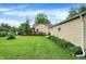 Spacious backyard featuring a deck with ramp, lush lawn, and mature trees at 6308 Ratliff Rd, Indianapolis, IN 46113