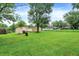 Spacious backyard with lush greenery and mature trees, perfect for outdoor activities at 6308 Ratliff Rd, Indianapolis, IN 46113