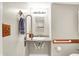 Accessible bathroom with grab bars, easy access sink, towel rack, and wall-mounted light fixture at 6308 Ratliff Rd, Indianapolis, IN 46113