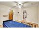 Well-lit bedroom featuring ceiling fan, hardwood floors, and comfortable hospital bed at 6308 Ratliff Rd, Indianapolis, IN 46113