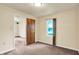 Bedroom showcasing neutral walls, carpet, and a window, offering a comfortable space at 6308 Ratliff Rd, Indianapolis, IN 46113